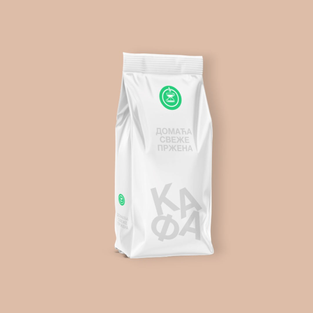 White coffee bag with green logo and text on a white background