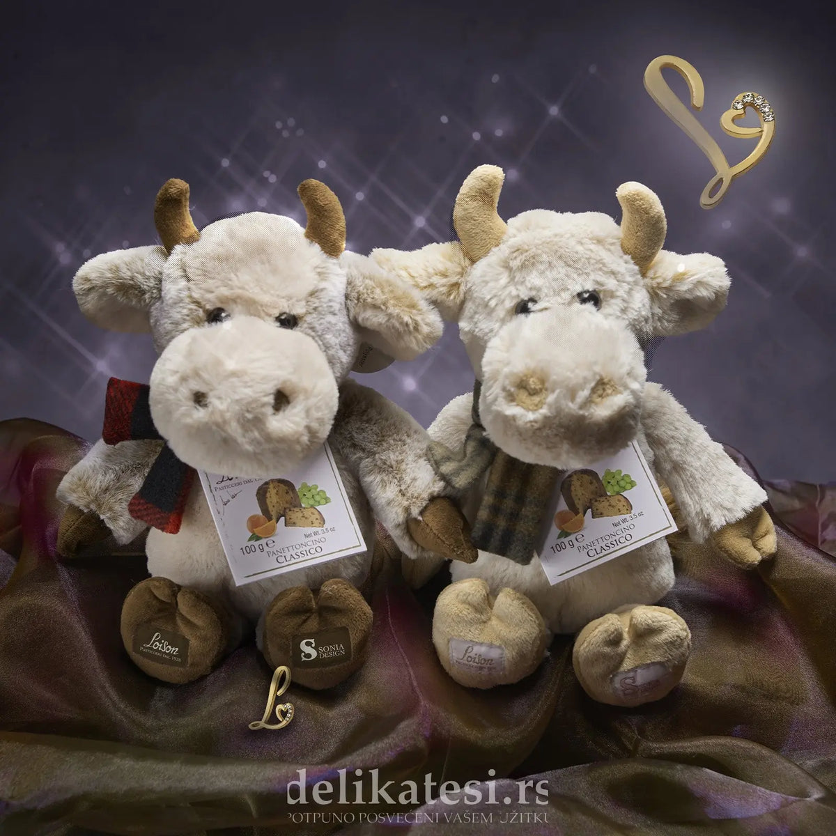 Two plush cow toys with tags on a dark background