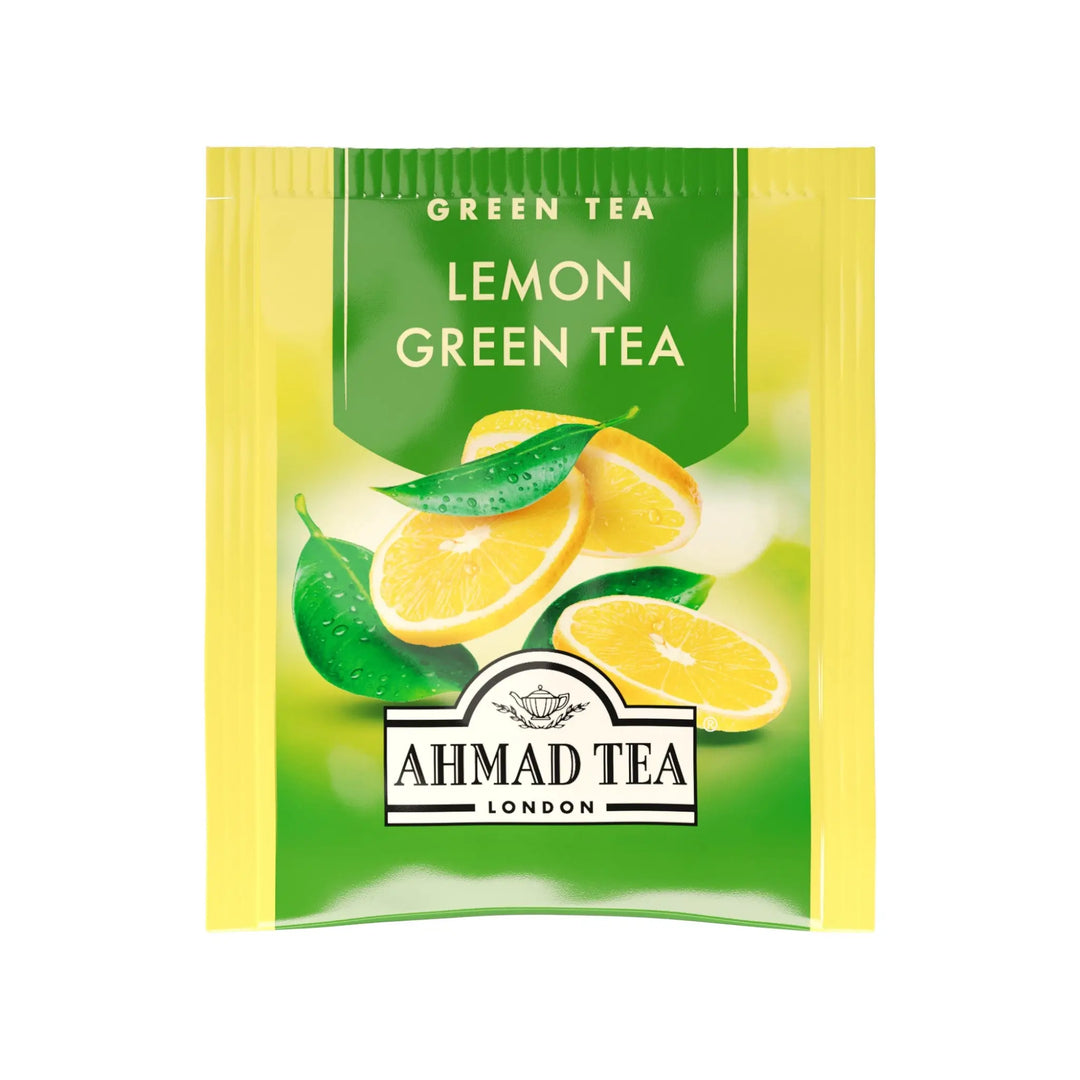 Delikatesi i tako to... Ahmad Tea Lemon Green tea bag sachet with fresh lemon slices and green leaves illustration