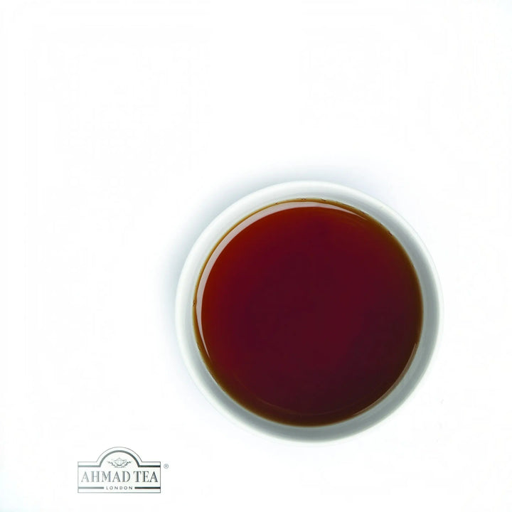 Delikatesi i tako to... Ahmad Tea Assam black tea in a white cup showing a rich amber infusion
