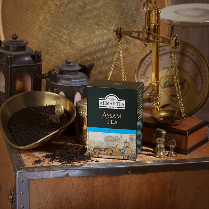 Delikatesi i tako to... Ahmad Tea Assam loose leaf black tea in a dark green box with vintage carriage illustration