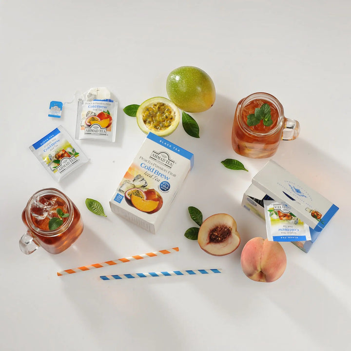 Delikatesi i tako to... Ahmad Tea Peach and Passion Fruit cold brew iced tea boxes, sachets, and glasses of iced tea.