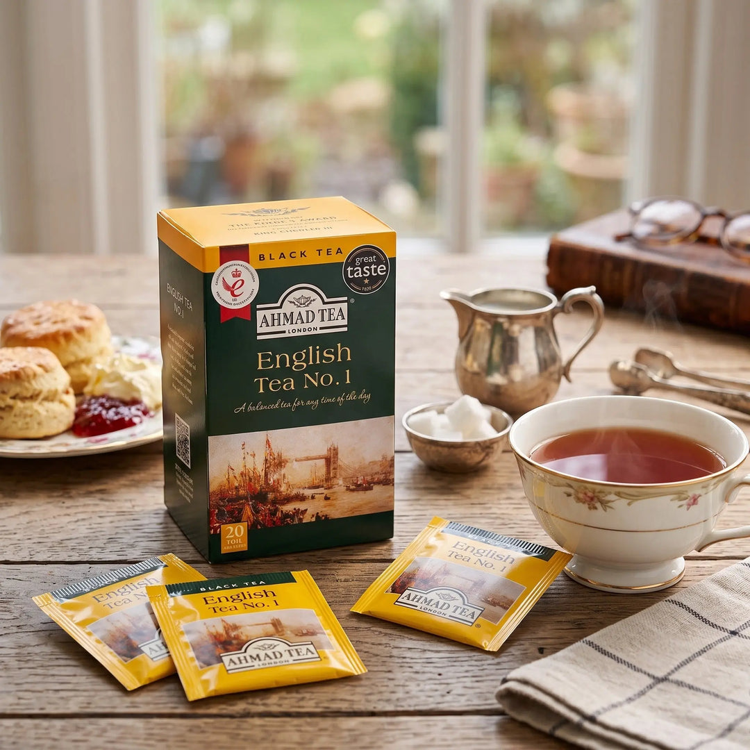 Delikatesi i tako to... Ahmad Tea English Tea No1 box with 20 foil tea bags on a wooden table with a cup of tea