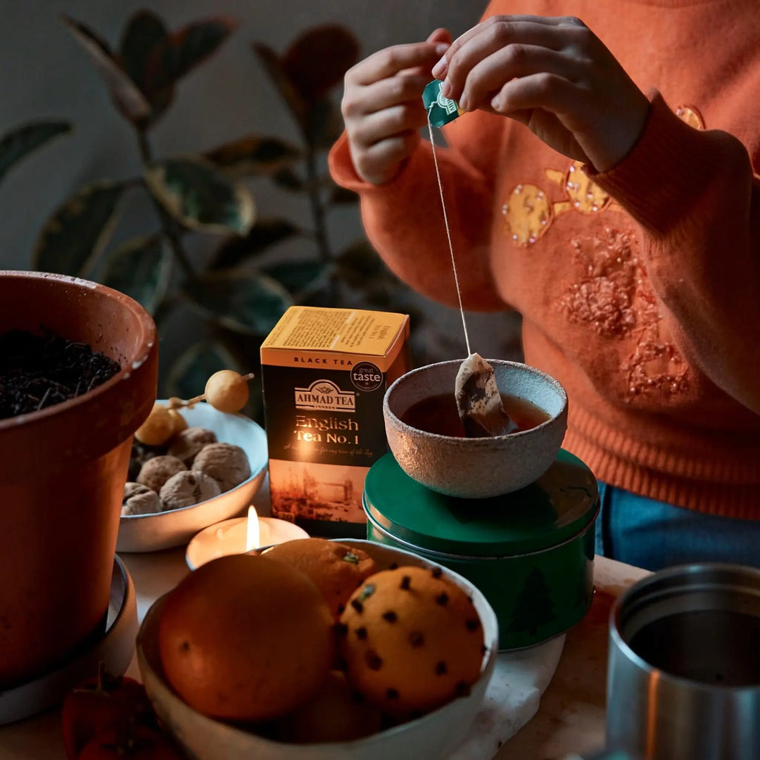 Delikatesi i tako to... Ahmad Tea English Tea No1 teabags being prepared in a cozy setting with oranges and walnuts