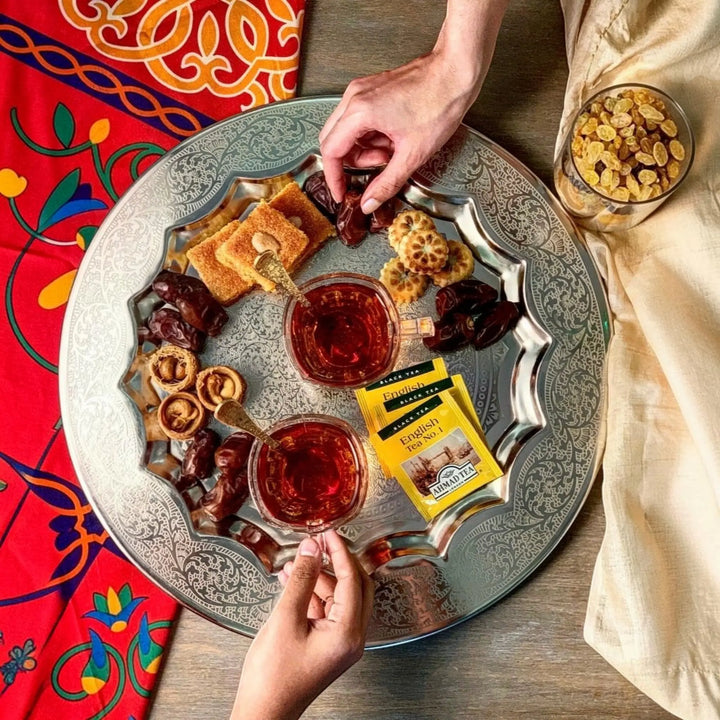 Delikatesi i tako to... Ahmad Tea English Tea No1 served with dates and pastries on an ornate silver tray