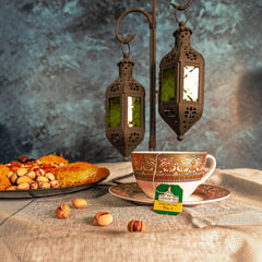 Delikatesi i tako to... Ahmad Tea English Tea No1 teabag in an ornate cup with lanterns and Middle Eastern pastries