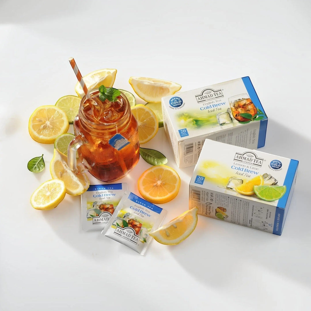 Delikatesi i tako to... Ahmad Tea Lemon & Lime cold brew iced tea boxes with a glass of iced tea and fresh citrus