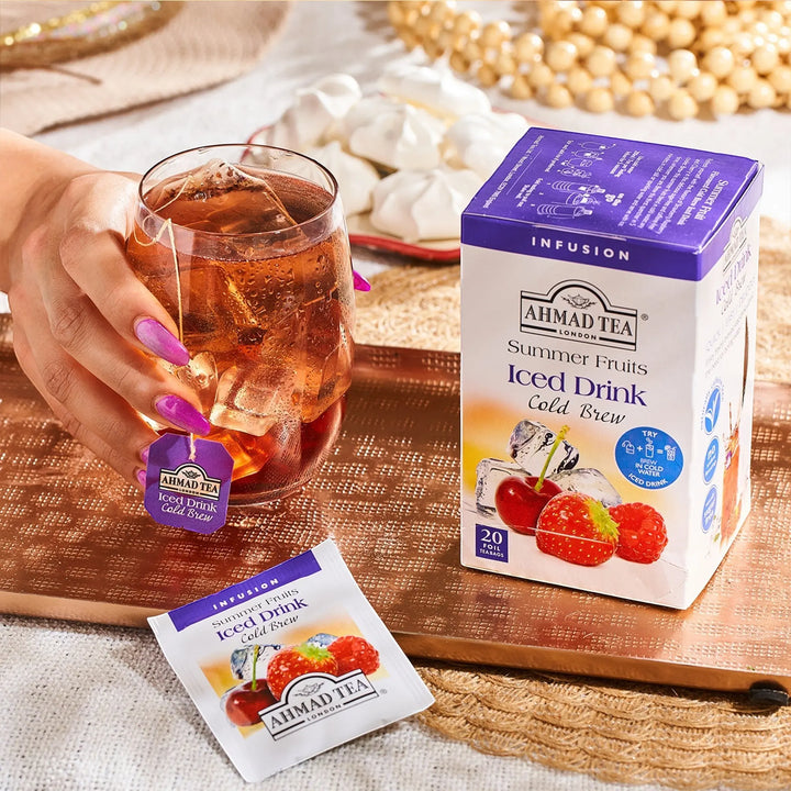 Delikatesi i tako to... Ahmad Tea Summer Fruits cold brew iced tea box and tea bag with a glass of iced fruit tea.