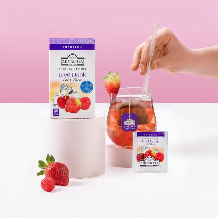 Delikatesi i tako to... Ahmad Tea Summer Fruits cold brew iced tea box, individual sachet, and glass with fruit.