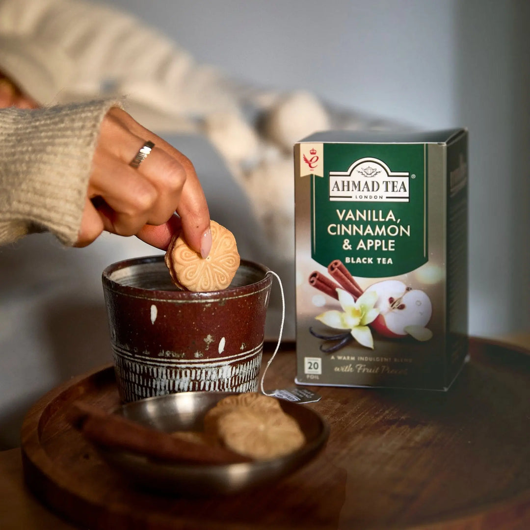 Delikatesi i tako to... Ahmad Tea vanilla, cinnamon and apple black tea bag being dipped into a rustic ceramic mug
