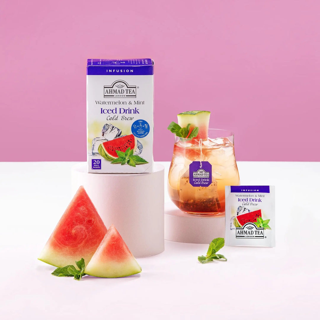 Delikatesi i tako to... Ahmad Tea Watermelon & Mint cold brew iced tea box, individual sachet, and glass with fruit.