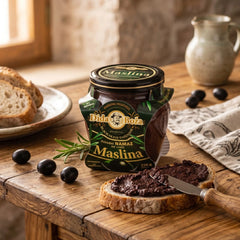Dida Boža black olive tapenade spread in a 190g glass jar, served on rustic bread by Delikatesi i tako to...
