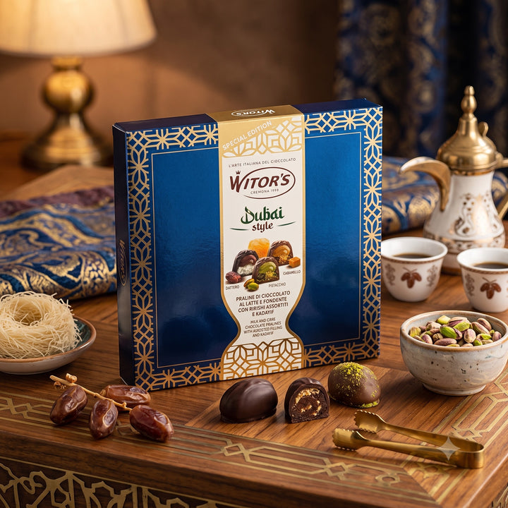 Delikatesi i tako to... Witor's Dubai Style praline chocolate box with pistachio and date fillings on a wooden table.