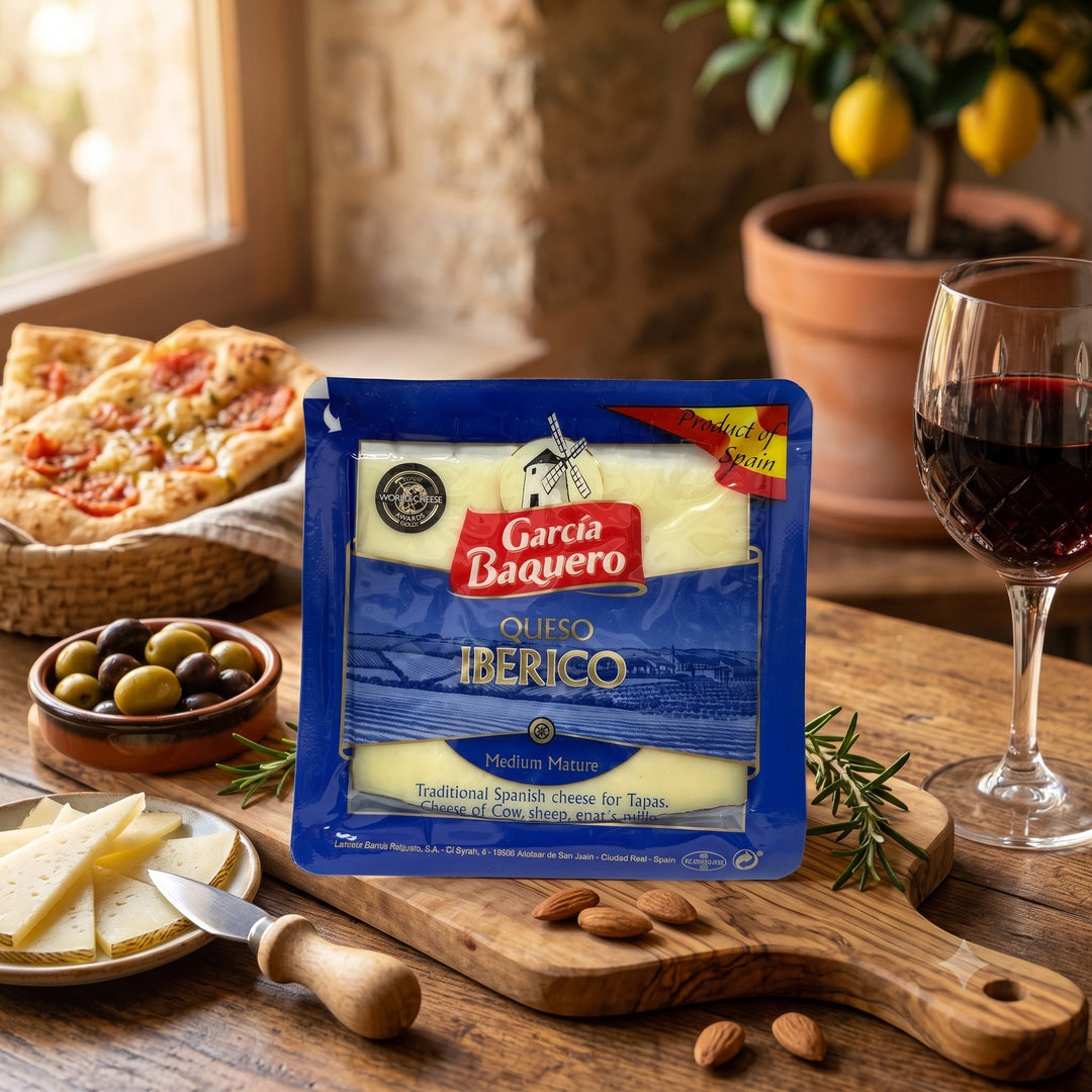 Delikatesi i tako to... Garcia Baquero Iberico cheese slices in blue packaging on a wooden board with wine and olives