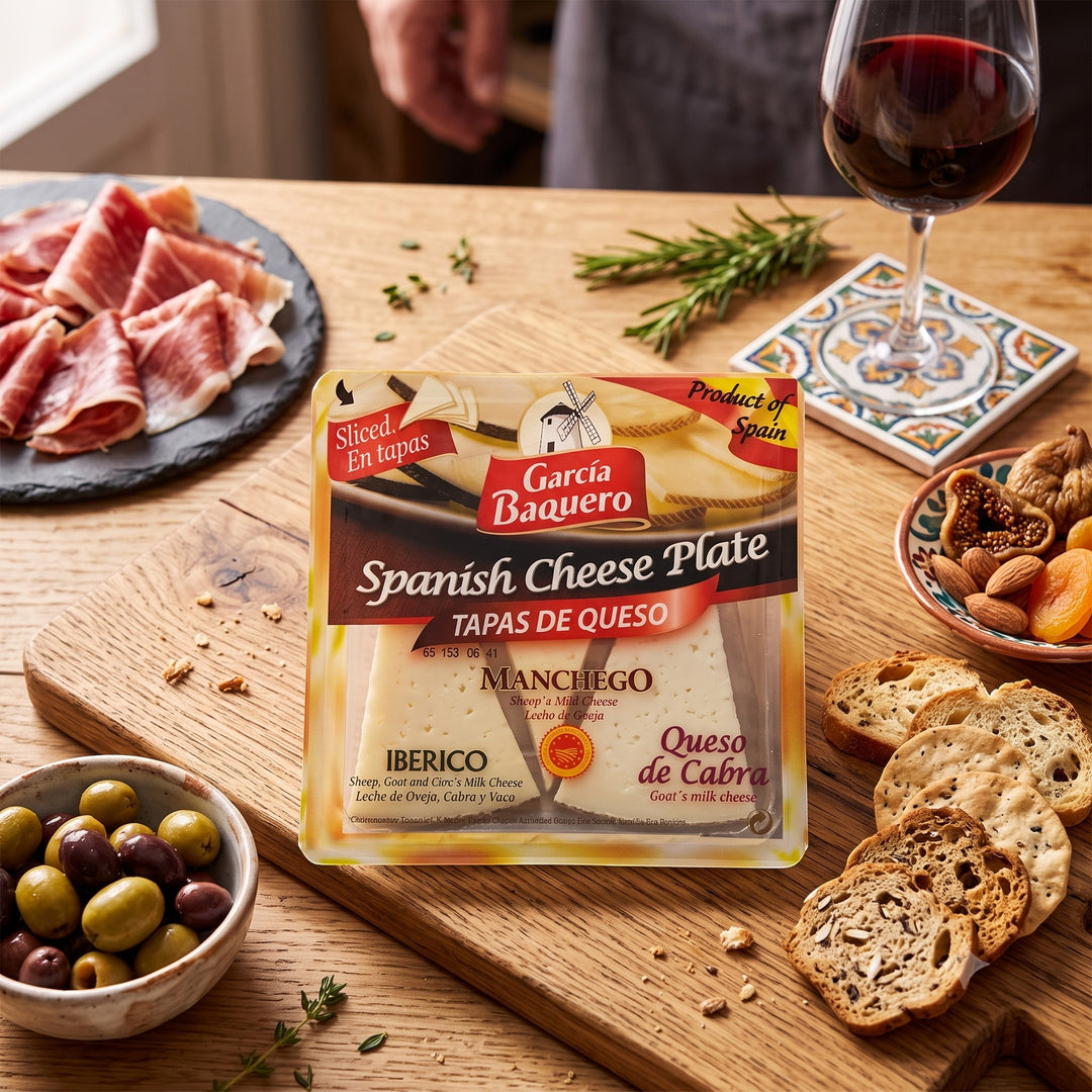 Delikatesi i tako to... Garcia Baquero Spanish cheese plate with Manchego, Iberico, and goat cheese slices on a board