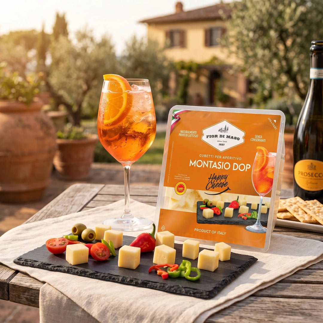 Delikatesi i tako to... Fior di Maso Montasio DOP cheese cubes served on a slate board with olives and peppers
