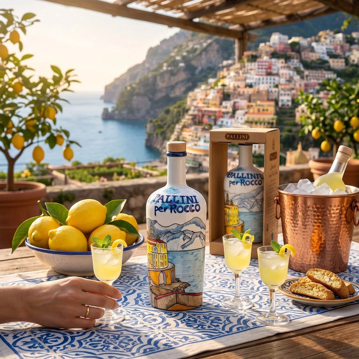 Delikatesi i tako to... Pallini Limoncello bottle with Amalfi coast illustration, served with glasses and lemons.