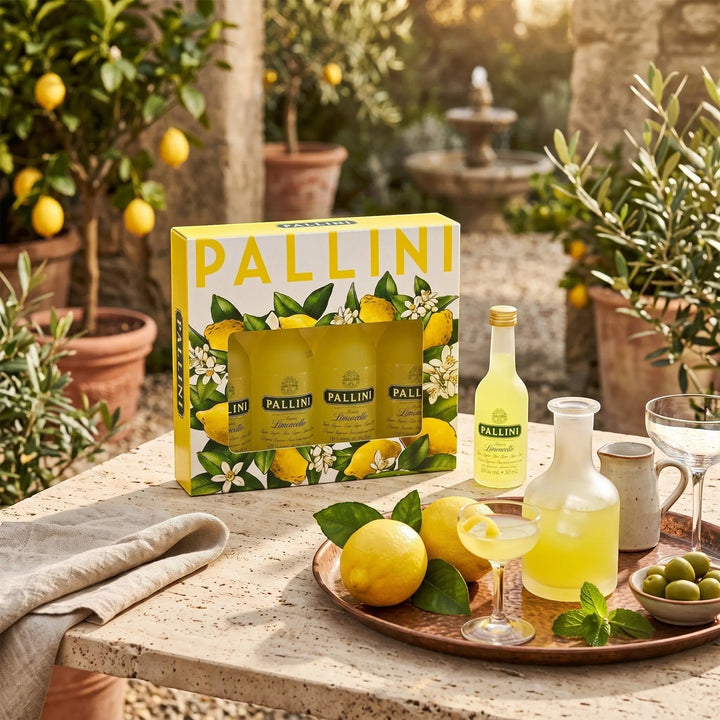 Delikatesi i tako to... Pallini Limoncello mini pack with six bottles, fresh lemons, and glassware on a stone table.