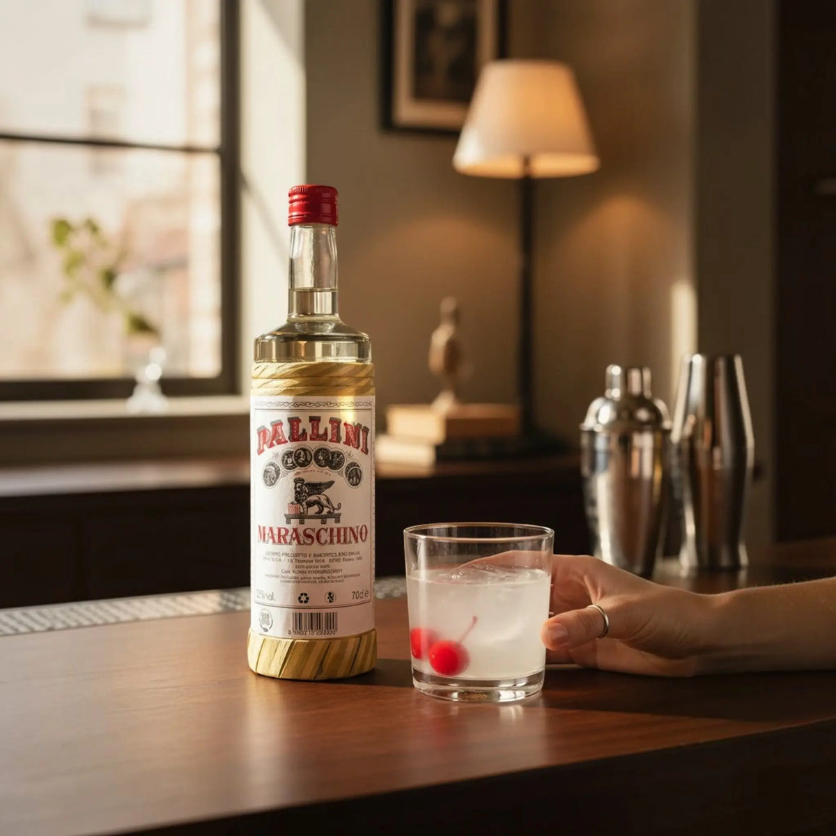 Delikatesi i tako to... Pallini Maraschino liqueur bottle next to a glass with ice and cherries on a wooden table