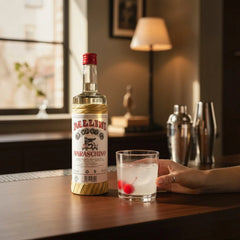 Delikatesi i tako to... Pallini Maraschino liqueur bottle next to a glass with ice and cherries on a wooden table
