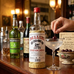 Delikatesi i tako to... Pallini Maraschino liqueur bottle on a wooden bar next to a cocktail with a cherry garnish