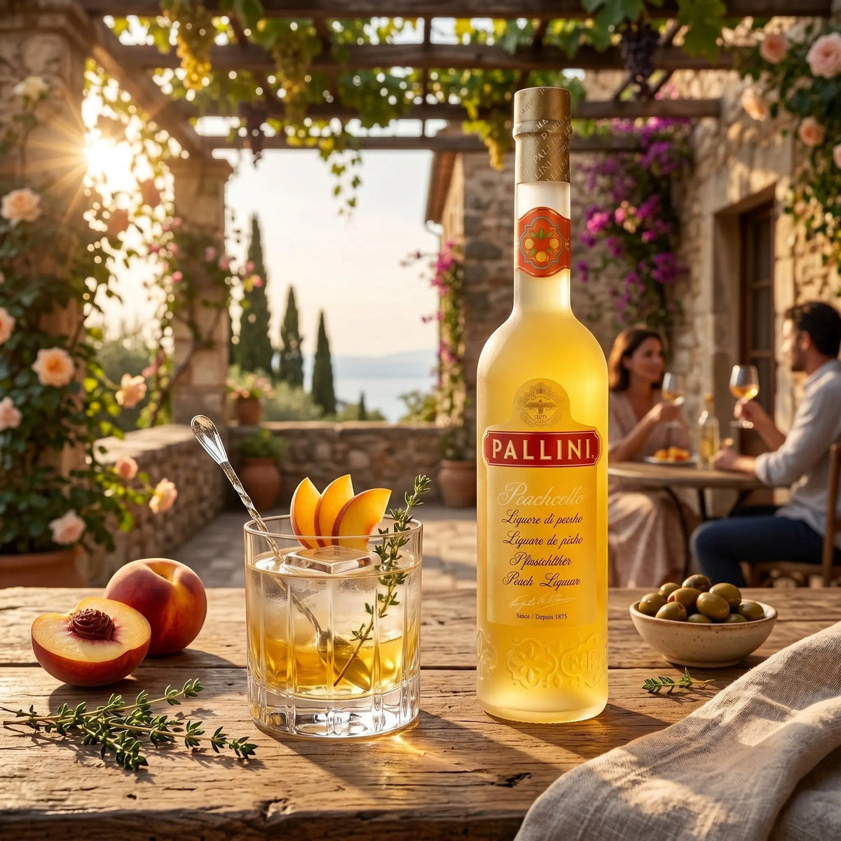 Delikatesi i tako to... Pallini Peachcello peach liqueur bottle with a cocktail on a rustic outdoor table at sunset