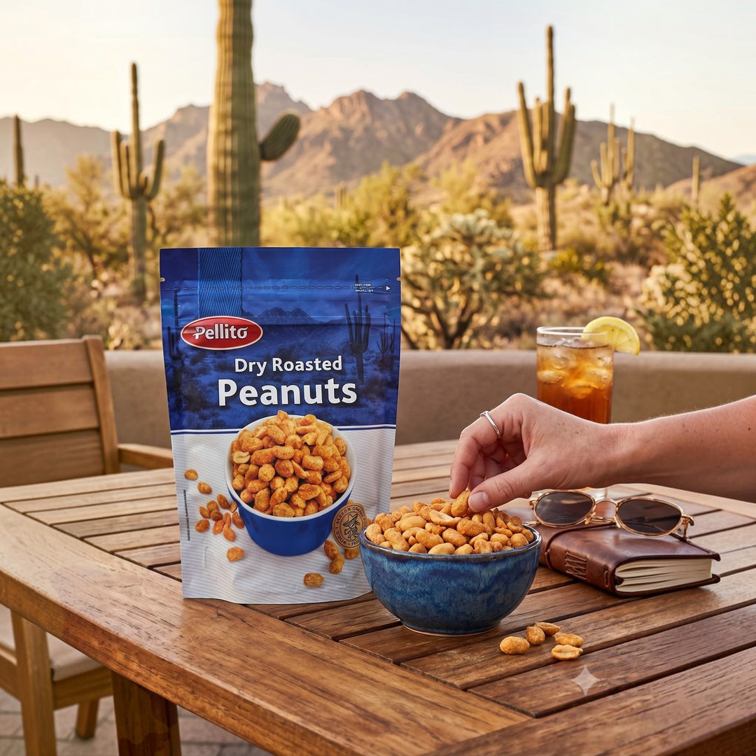 Delikatesi i tako to... Pellito dry roasted salted peanuts in a blue bowl on a wooden table with a desert background.