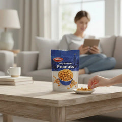 Delikatesi i tako to... Pellito dry roasted salted peanuts in a 150g bag on a table with a person snacking nearby.