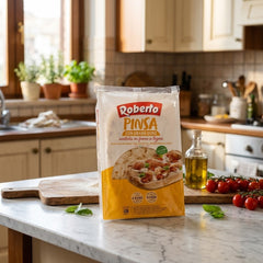 Delikatesi i tako to Roberto wood-fired pinsa dough in plastic packaging on a kitchen counter.