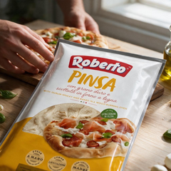 Roberto wood-fired pinsa dough base in plastic packaging with Italian branding and serving suggestion