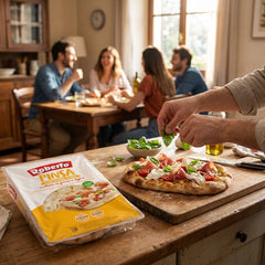 Delikatesi i tako to Roberto pinsa crust with prosciutto and tomatoes on a wooden board with people dining in background