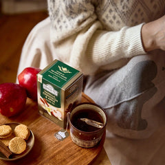 Delikatesi i tako to... Ahmad Tea Vanilla, Cinnamon & Apple tea box with a warm cup of tea, apples, and cookies.