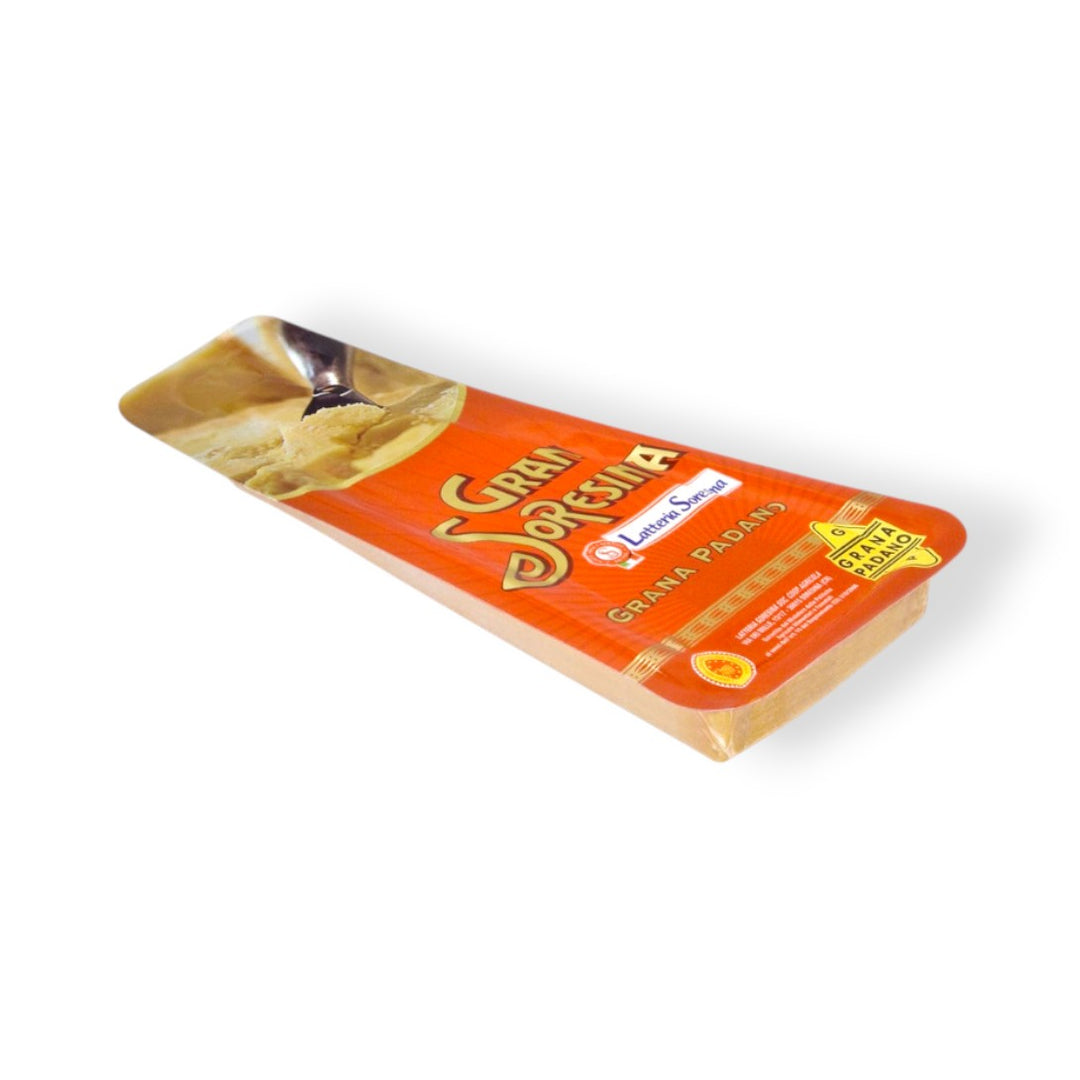 Packaged Grana Padano cheese with branding and product information visible on the label.